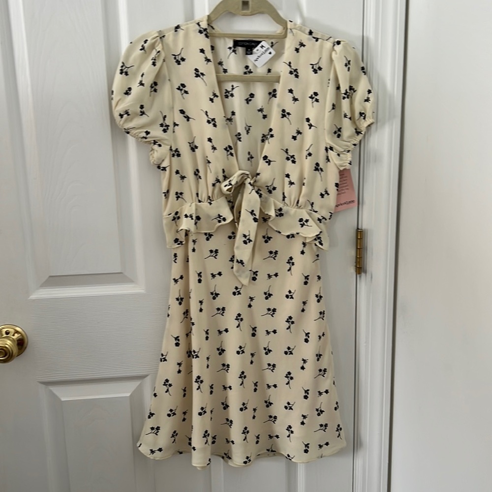 White dress with black flower detailing